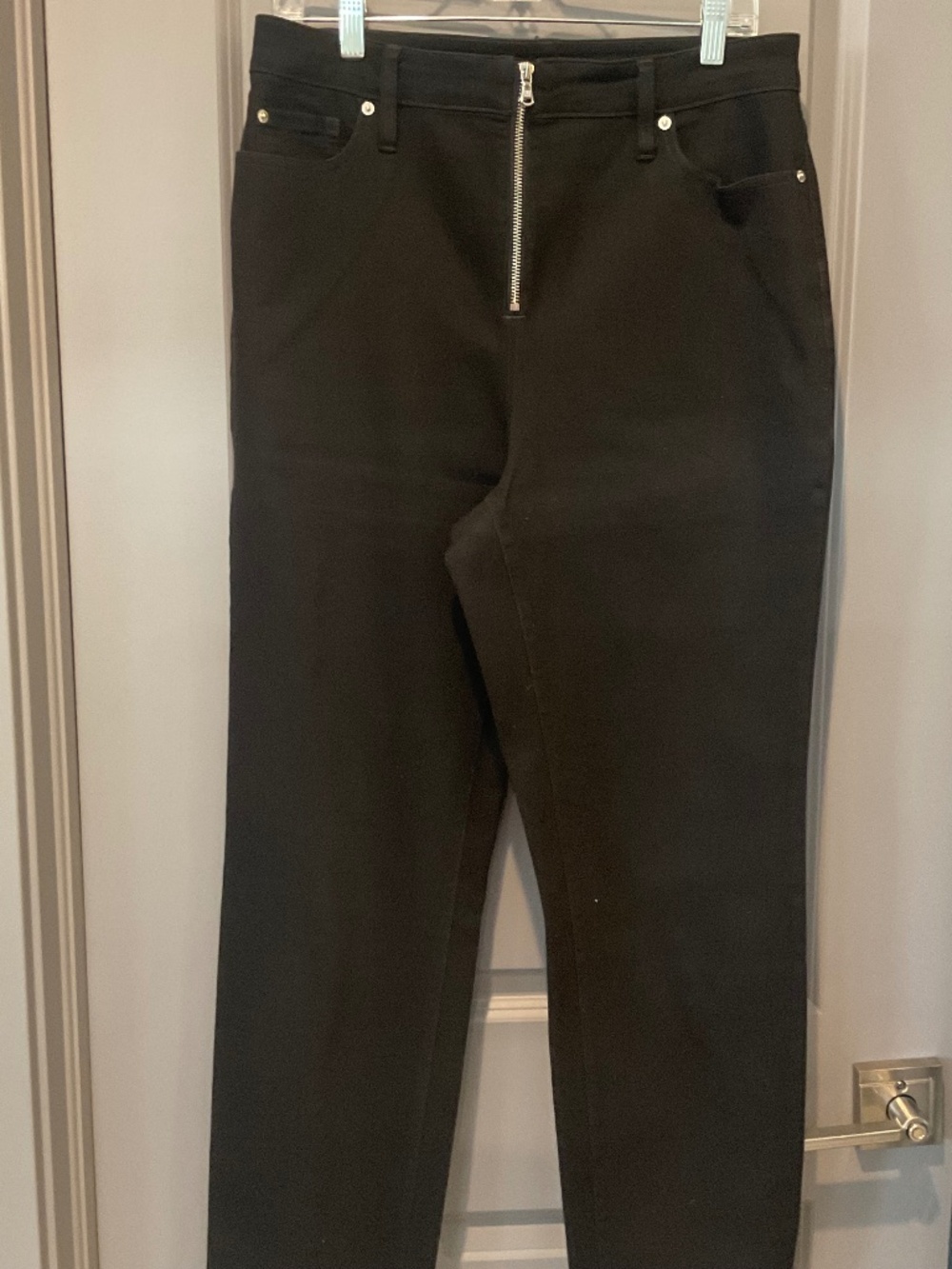 Black jeans with front silver zipper closure
